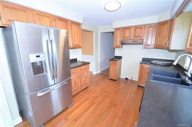 Another view of the kitchen with included refriger
