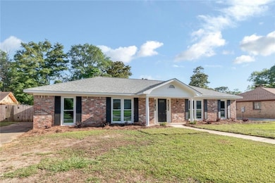Ranch-style house with brick siding and roof with shingles