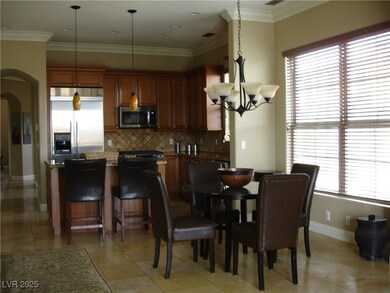 Dining room featuring arched walkways, a chandelie