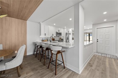 Kitchen featuring white cabinets, kitchen peninsul