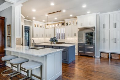 Kitchen with tasteful backsplash, blue cabinetry, 