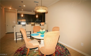 Dining space featuring crown molding, recessed lighting, and a chandelier