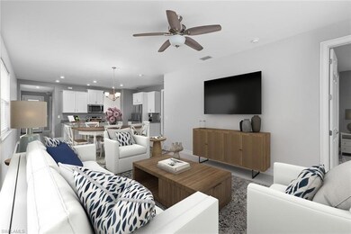 Living room featuring ceiling fan with notable cha