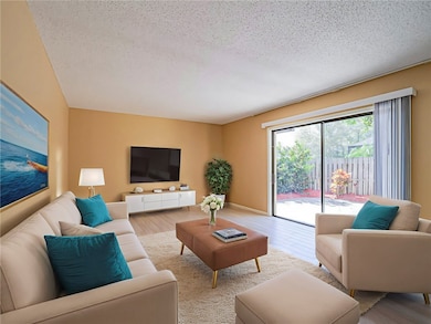 Living area virtually staged w/wood tile floors