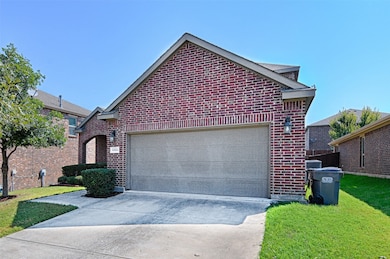 View of property exterior featuring concrete driveway, brick siding, an attached garage, and a yard