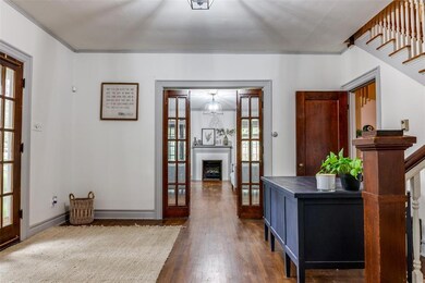 View from the den looking into the entryway and li