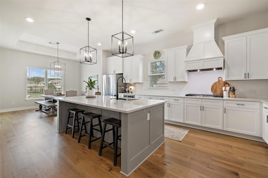 Kitchen featuring a sink, a chandelier, recessed 