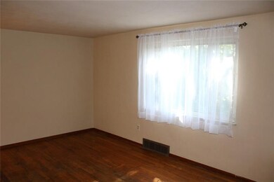 LARGE LIVING ROOM WITH HARDWOOD FLOORS.