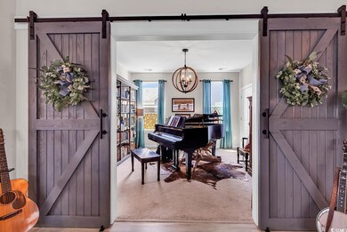 Interior space featuring a chandelier, a barn door