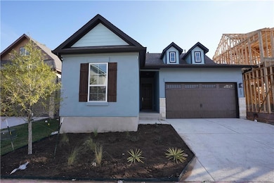 View of front of home with a garage and driveway