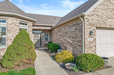 Lovely landscaping and covered porch greets guests.