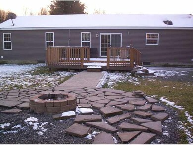 Exterior Back concret patio to fire pit just about