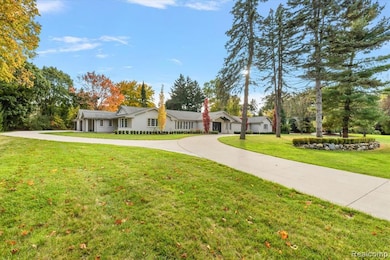 Single story home with concrete driveway, a front yard, and a chimney