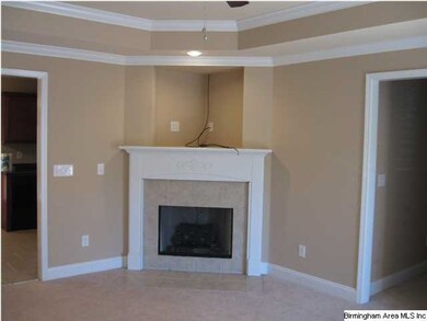 Living room and fireplace with entrance to kitchen