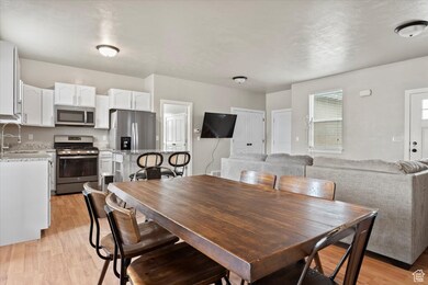 Dining area with light wood-style floors