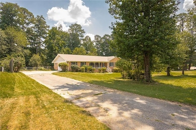 View of front of house with driveway and brick siding