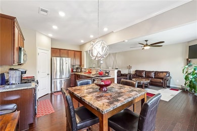 Dining room with dark wood-style floors, recessed lighting, ceiling fan, crown molding, and baseboards