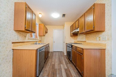 Kitchen featuring dark wood-type flooring, sink, s