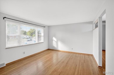 Unfurnished bedroom featuring wood finished floors and a closet