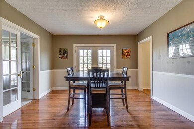 Dining room opens up to deck overlooking large back yard.