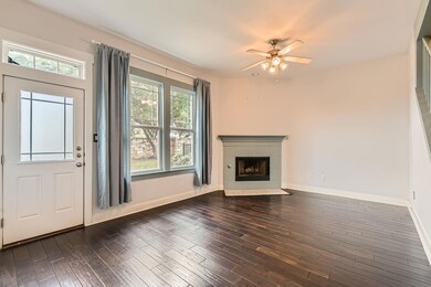 Unfurnished living room with a tiled fireplace, b