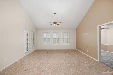 Tiled spare room featuring ceiling fan and high vaulted ceiling