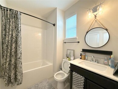 Full bathroom featuring shower / tub combo with curtain, vanity, and wood finished floors