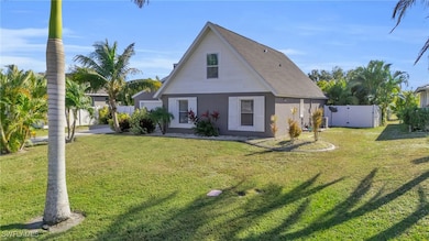 Back of property featuring a yard