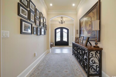 Tiled foyer featuring an inviting chandelier and c