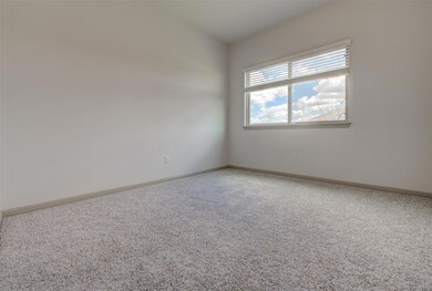 Empty room with carpet flooring and baseboards