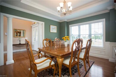 Formal dining area with hardwood floors and crown 
