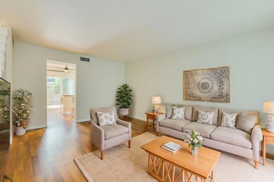 Living room with wood finished floors and baseboa