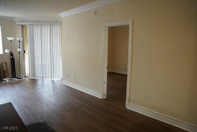 Spare room featuring crown molding, wood finished