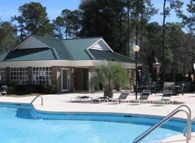 Community pool with a patio