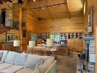 Living room with beam ceiling, wood walls, ceiling