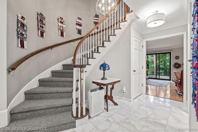 Marble foyer with circular staircae. . .