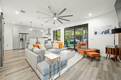Living area featuring a ceiling fan, light wood-s