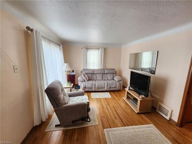 Living room with light hardwood floors and a textu
