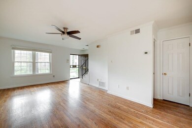 Empty room with crown molding, light wood-type flo