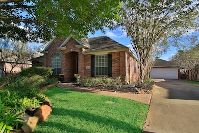 The house has a welcoming front entrance with stamped concrete walkway.