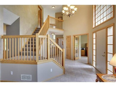 Spacious entry with tile flooring, split stair cas