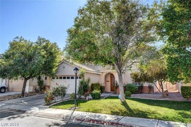Beautiful front yard with mature trees and landsca