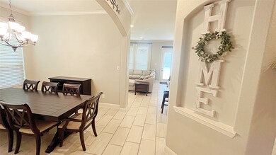 Elegant dining room with crown molding and freshly painted.