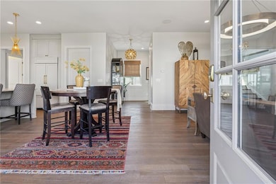 Dining area with baseboards, dark wood-style floor