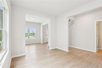 Unfurnished room with light wood-type flooring and baseboards
