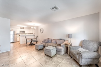 Living room featuring a chandelier and light tile patterned floors