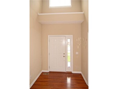 Entry. A two story foyer with plant shelf and window lets the natural light in!  Crisp white trim and matching door...