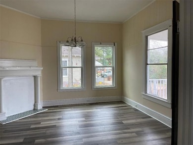Unfurnished dining area with crown molding, a healthy amount of sunlight, and an inviting chandelier