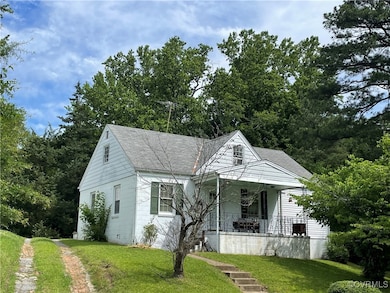 Bungalow with a front yard, a porch, and a shingle