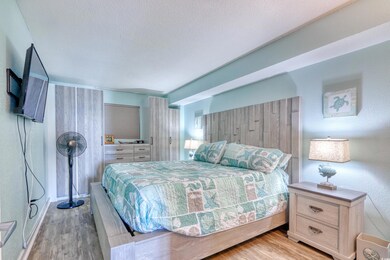 Bedroom featuring light wood-style flooring and a textured ceiling